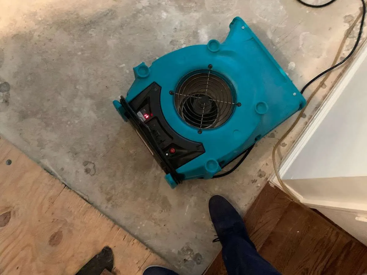 Air mover drying subfloor during Commercial Water Damage Restoration in Deerfield